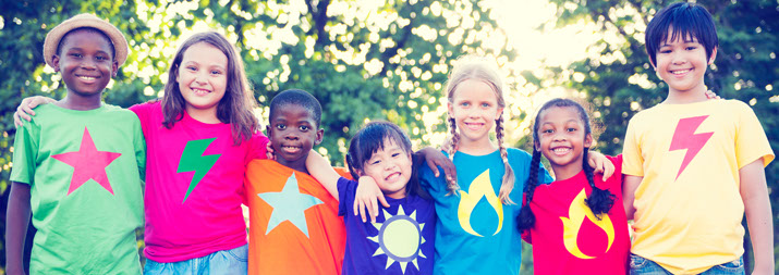 Group of children hugging with colourful t-shirts